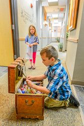 Boy at the dentist choosing a toy from a treasure box